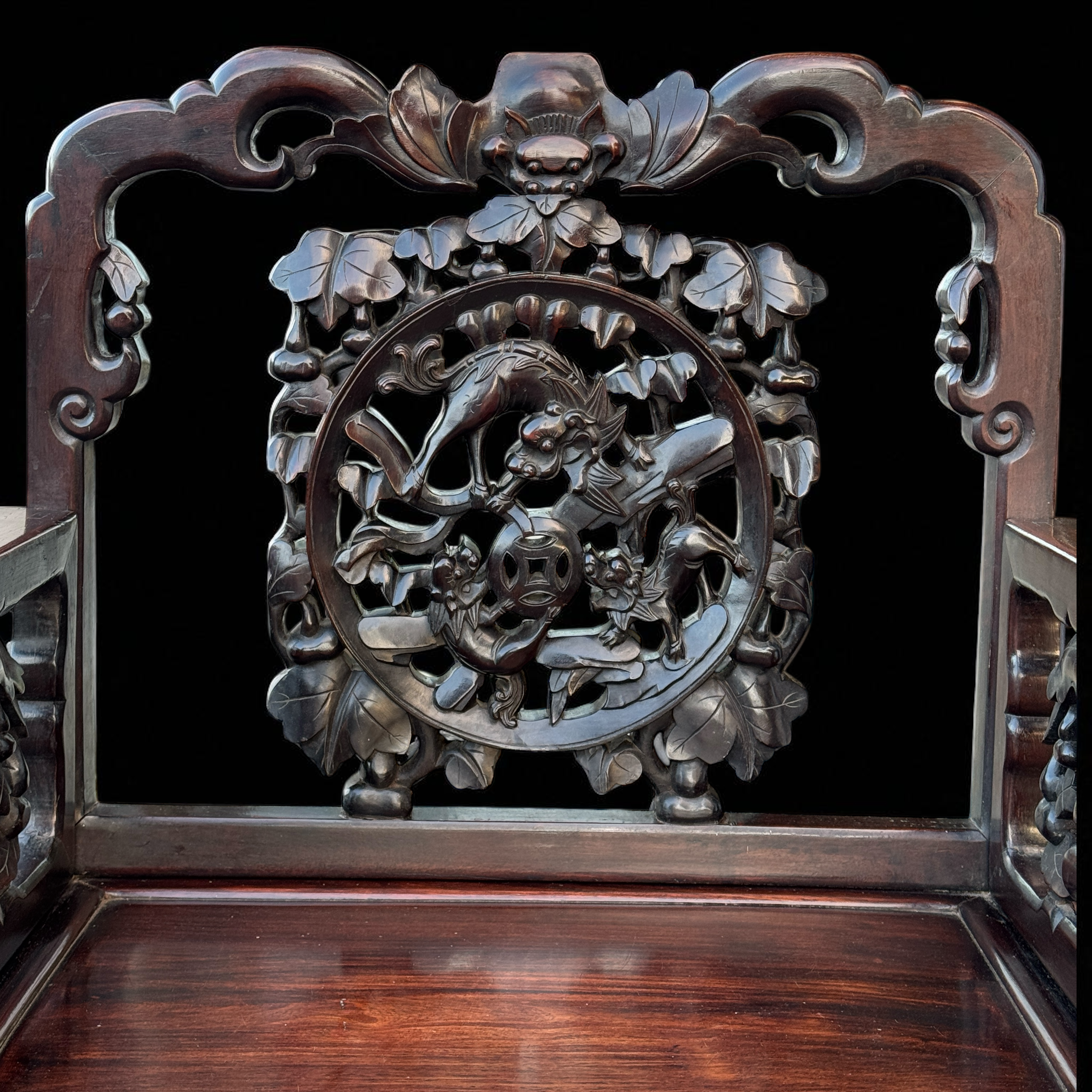 Qing armchair — back crest rail with cloud and bat carving